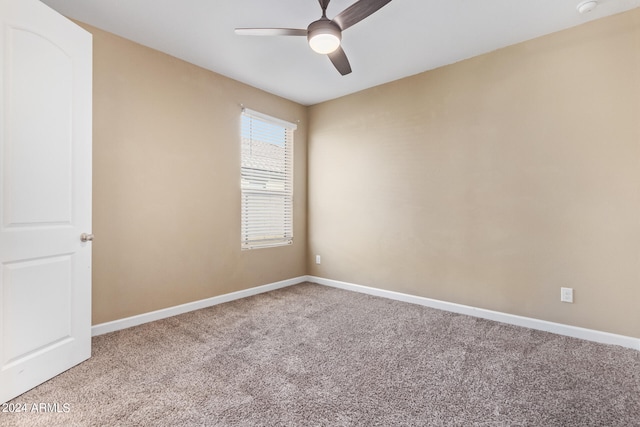 carpeted empty room featuring ceiling fan