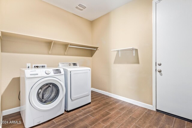 laundry area featuring dark hardwood / wood-style floors and washer and dryer