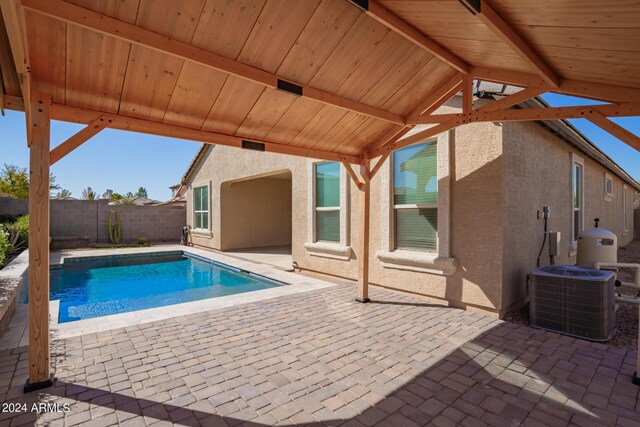 view of swimming pool with central AC and a patio area