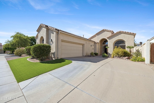 11816 E Terra Dr, Scottsdale, AZ 85259 - mediterranean / spanish-style home featuring driveway, stucco siding, an attached garage, and a tiled roof