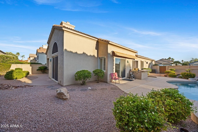 11816 E Terra Dr, Scottsdale, AZ 85259 - rear view of house featuring a chimney, a patio, stucco siding, and a fenced backyard