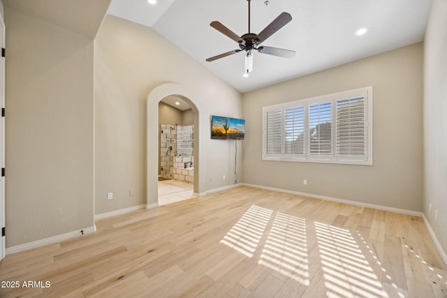 11816 E Terra Dr, Scottsdale, AZ 85259 - spare room featuring lofted ceiling, arched walkways, wood finished floors, ceiling fan, and recessed lighting