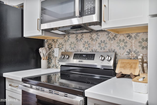 kitchen featuring decorative backsplash, white cabinetry, stainless steel appliances, and light countertops