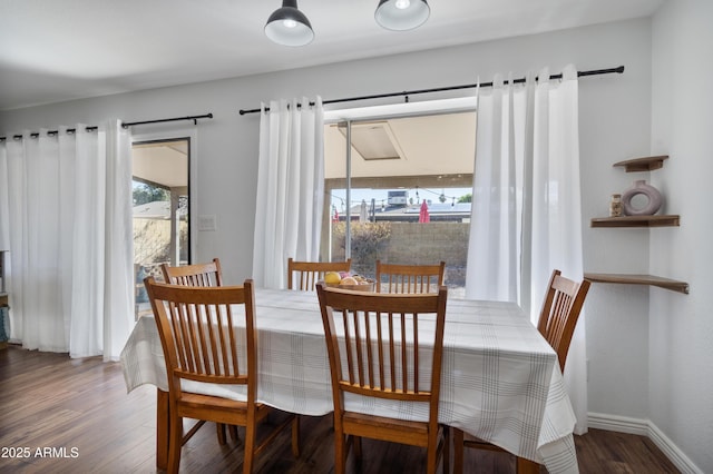 dining room with baseboards and wood finished floors