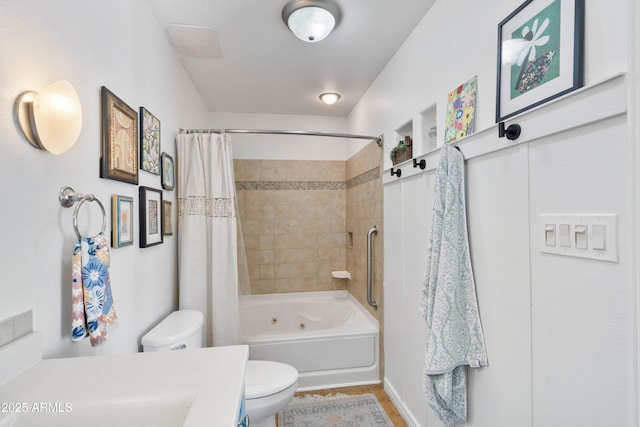 full bathroom featuring shower / bath combo with shower curtain, toilet, wood finished floors, and vanity