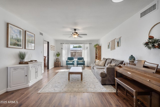 living area featuring visible vents, ceiling fan, and wood finished floors