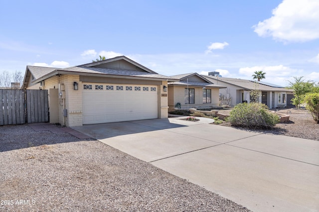 single story home with fence, concrete driveway, an attached garage, and a gate