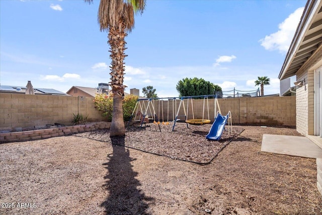 view of yard featuring a playground and a fenced backyard