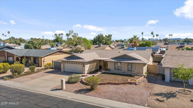 ranch-style house with fence, a residential view, a garage, and driveway