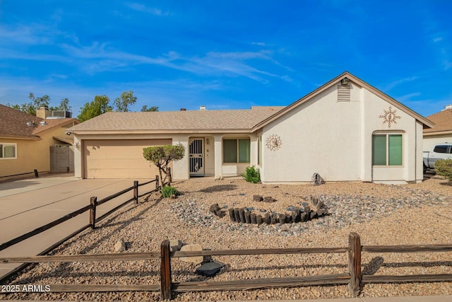 ranch-style home with an attached garage, fence, concrete driveway, and stucco siding