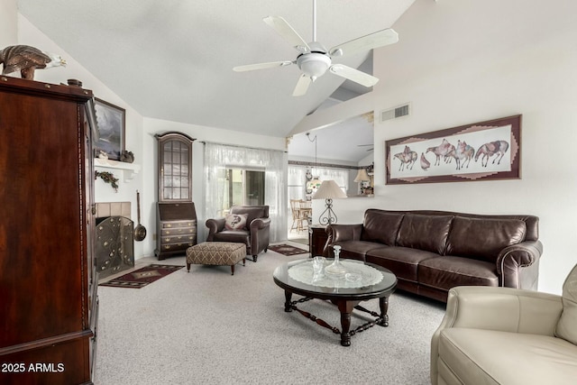 carpeted living area with a ceiling fan, visible vents, a fireplace, and high vaulted ceiling