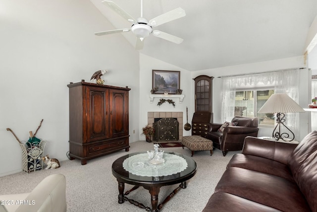 carpeted living room with ceiling fan, high vaulted ceiling, and a tile fireplace