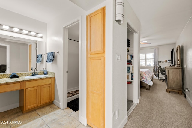 bathroom featuring tile patterned flooring, ceiling fan, and vanity