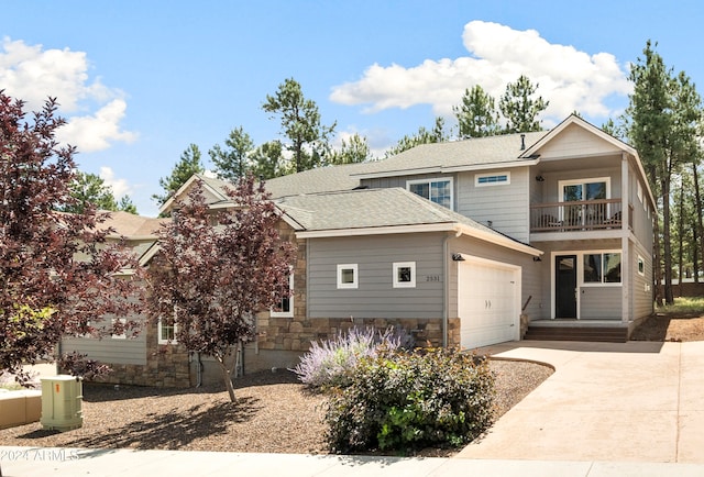 back of property with a garage and a balcony