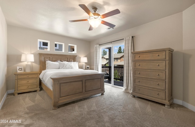 carpeted bedroom featuring access to exterior and ceiling fan