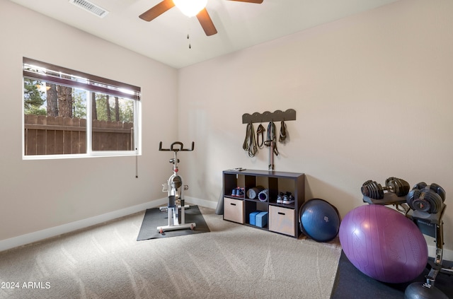 exercise area with ceiling fan and carpet floors