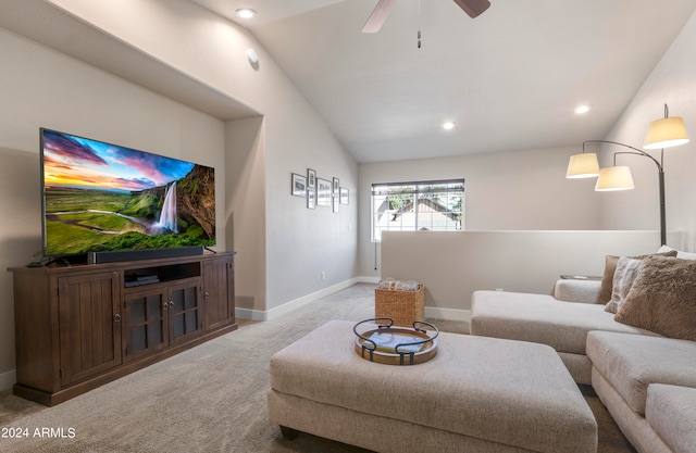 carpeted living room with ceiling fan and vaulted ceiling