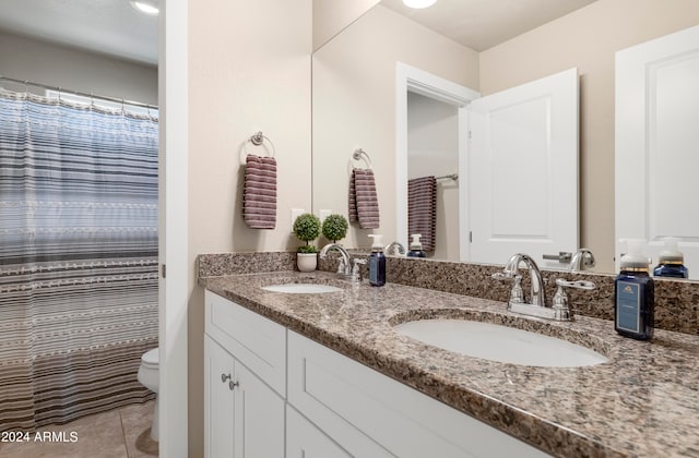 bathroom featuring tile patterned floors, toilet, and vanity