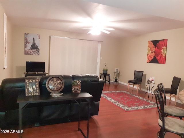living room with wood finished floors, ceiling fan, and baseboards