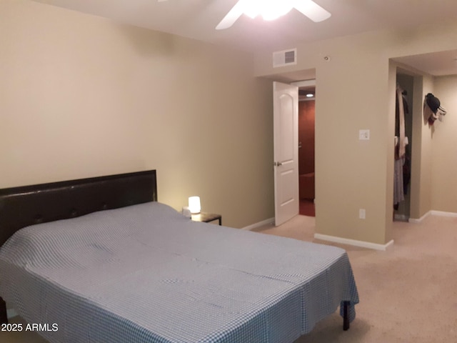 bedroom featuring light colored carpet, baseboards, and a ceiling fan