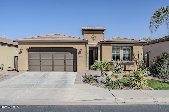 prairie-style house featuring a garage, concrete driveway, a tile roof, and stucco siding