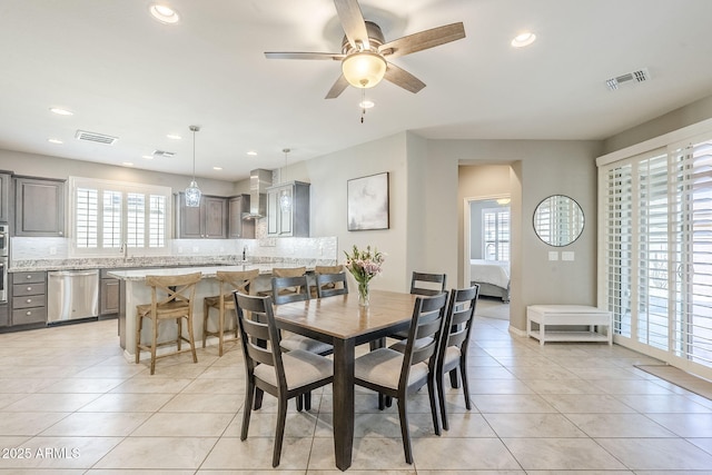 dining space with light tile patterned floors, visible vents, and recessed lighting