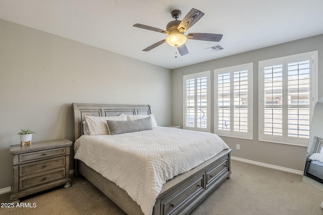 bedroom with light carpet, multiple windows, visible vents, and baseboards