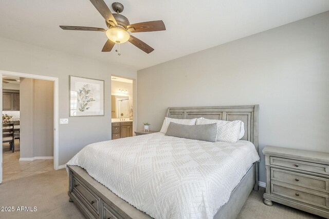 bedroom with light carpet, baseboards, a ceiling fan, and ensuite bathroom