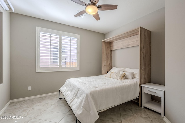 tiled bedroom with a ceiling fan and baseboards