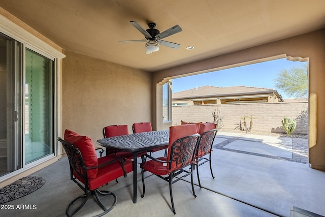 view of patio / terrace featuring fence, a ceiling fan, and outdoor dining space