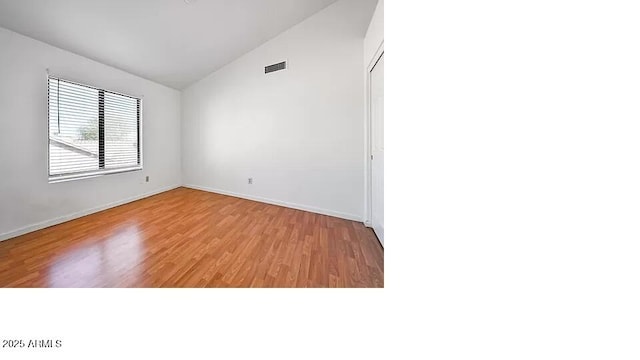 3761 W Kent Dr, Chandler, AZ 85226 - unfurnished room featuring visible vents, baseboards, light wood finished floors, and lofted ceiling