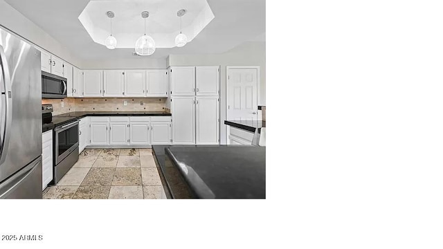 3761 W Kent Dr, Chandler, AZ 85226 - kitchen featuring white cabinets, appliances with stainless steel finishes, a tray ceiling, and dark countertops