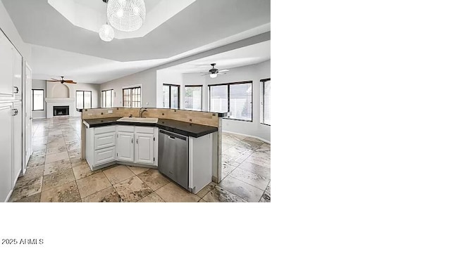 3761 W Kent Dr, Chandler, AZ 85226 - kitchen featuring a sink, a fireplace, a ceiling fan, open floor plan, and stainless steel dishwasher