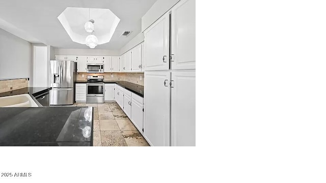 3761 W Kent Dr, Chandler, AZ 85226 - kitchen featuring visible vents, dark countertops, appliances with stainless steel finishes, white cabinets, and a notable chandelier