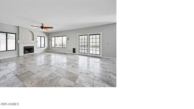 3761 W Kent Dr, Chandler, AZ 85226 - unfurnished living room with baseboards, stone tile floors, ceiling fan, and a fireplace