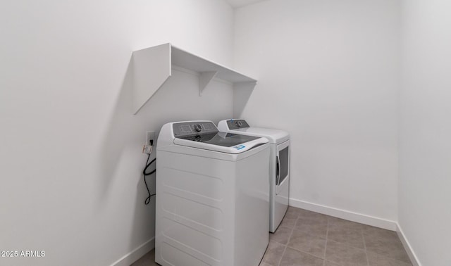 washroom featuring light tile patterned floors and washer and clothes dryer