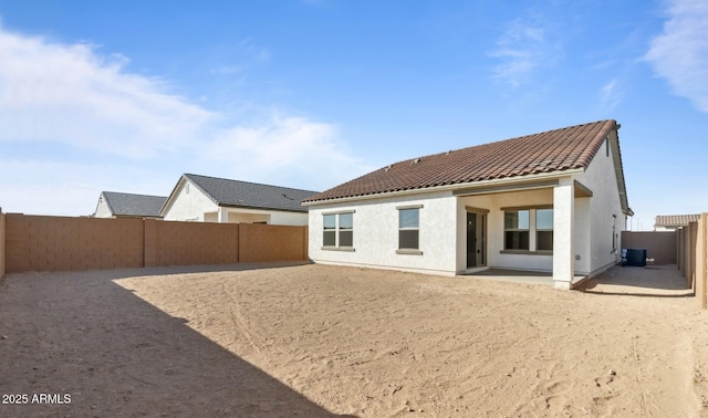 rear view of house with a patio and central AC unit