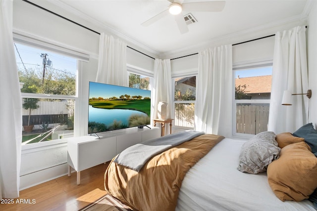 905 E Coronado Rd, Phoenix, AZ 85006 - bedroom with ornamental molding, wood finished floors, multiple windows, and ceiling fan