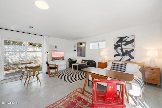 905 E Coronado Rd, Phoenix, AZ 85006 - living area with concrete flooring and an AC wall unit