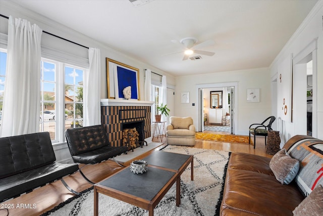 905 E Coronado Rd, Phoenix, AZ 85006 - living room featuring wood finished floors, healthy amount of natural light, a ceiling fan, a brick fireplace, and crown molding