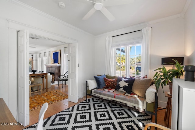 905 E Coronado Rd, Phoenix, AZ 85006 - living area featuring ornamental molding, wood finished floors, ceiling fan, a fireplace, and baseboards