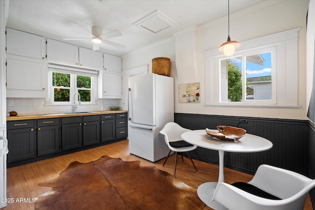 905 E Coronado Rd, Phoenix, AZ 85006 - kitchen with freestanding refrigerator, a sink, ornamental molding, light wood finished floors, and backsplash