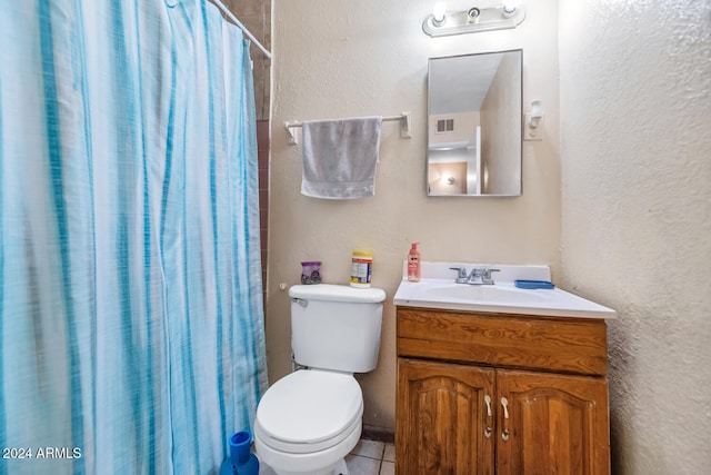 bathroom with toilet, a shower with curtain, vanity, and tile patterned floors