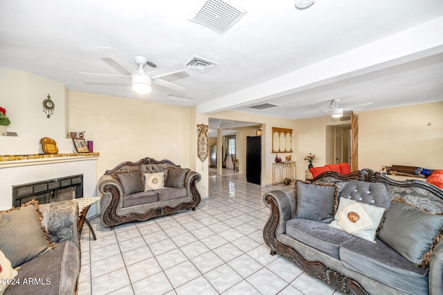 living room with ceiling fan and light tile patterned flooring