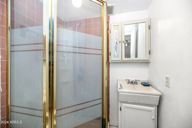 bathroom with vanity and an enclosed shower