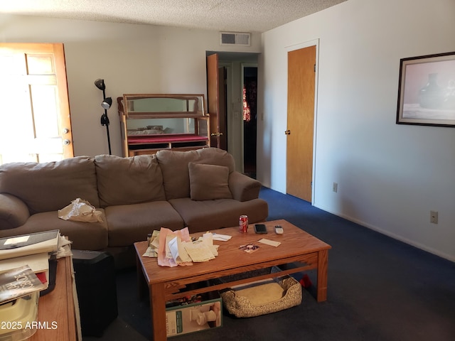 living room featuring a textured ceiling and carpet