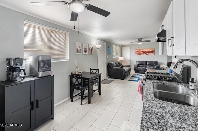 3806 N 64th Dr, Phoenix, AZ 85033 - kitchen with a ceiling fan, a sink, white cabinetry, under cabinet range hood, and open floor plan