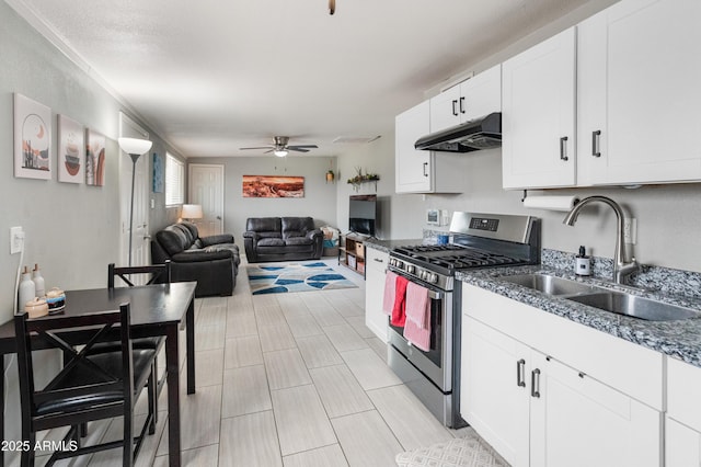3806 N 64th Dr, Phoenix, AZ 85033 - kitchen featuring stainless steel gas range, under cabinet range hood, a sink, ceiling fan, and white cabinets