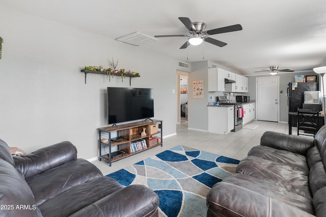 3806 N 64th Dr, Phoenix, AZ 85033 - living room featuring ceiling fan and baseboards