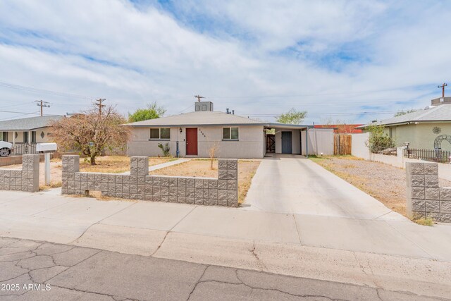 3806 N 64th Dr, Phoenix, AZ 85033 - view of front of house featuring concrete driveway, fence, and an attached carport